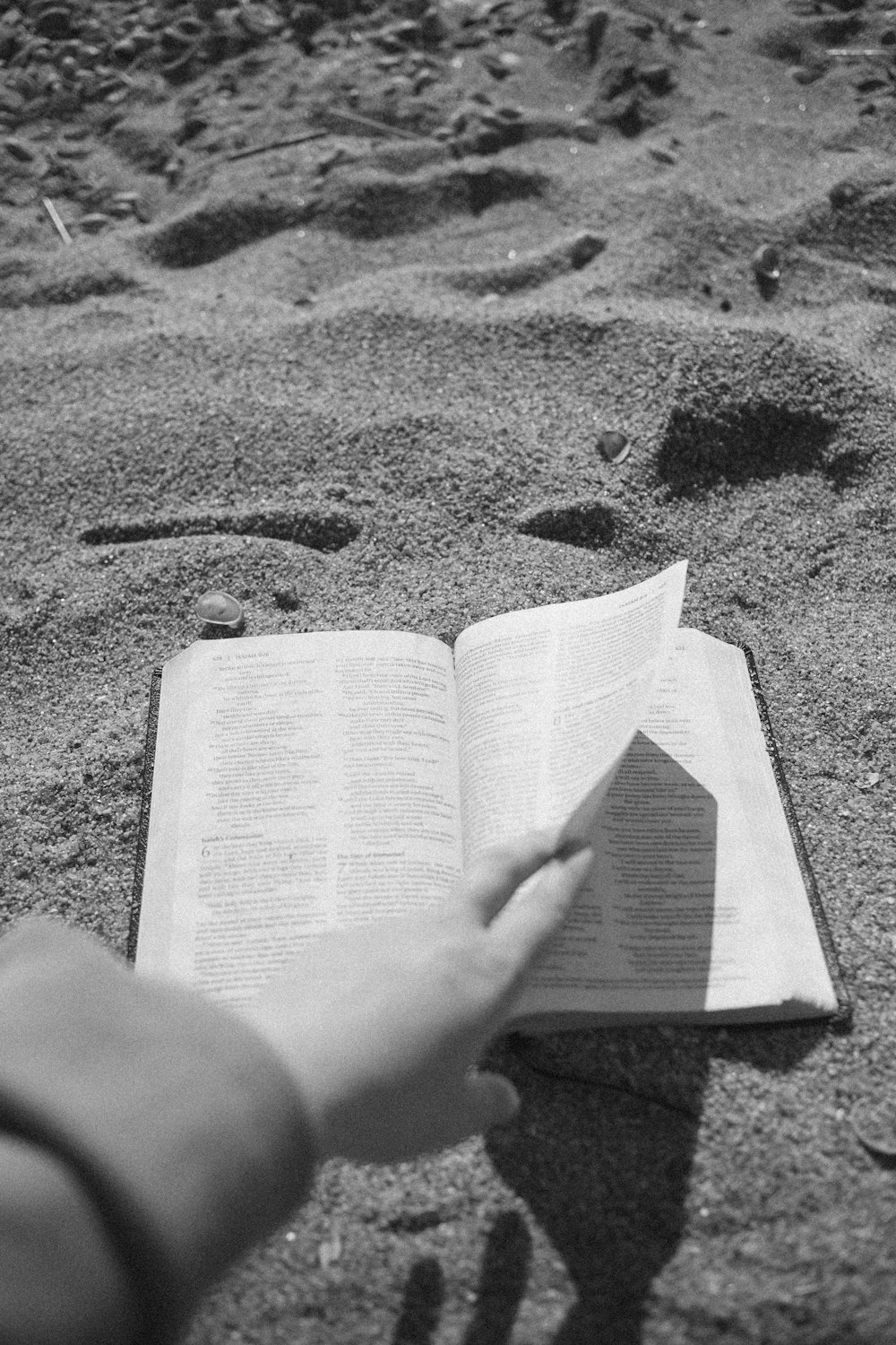 a person is reading a book on the beach