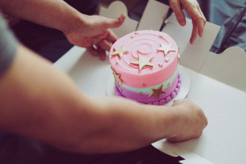 a person cutting a cake with a knife