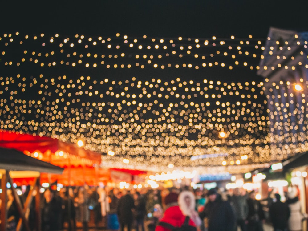 a crowd of people standing around a market