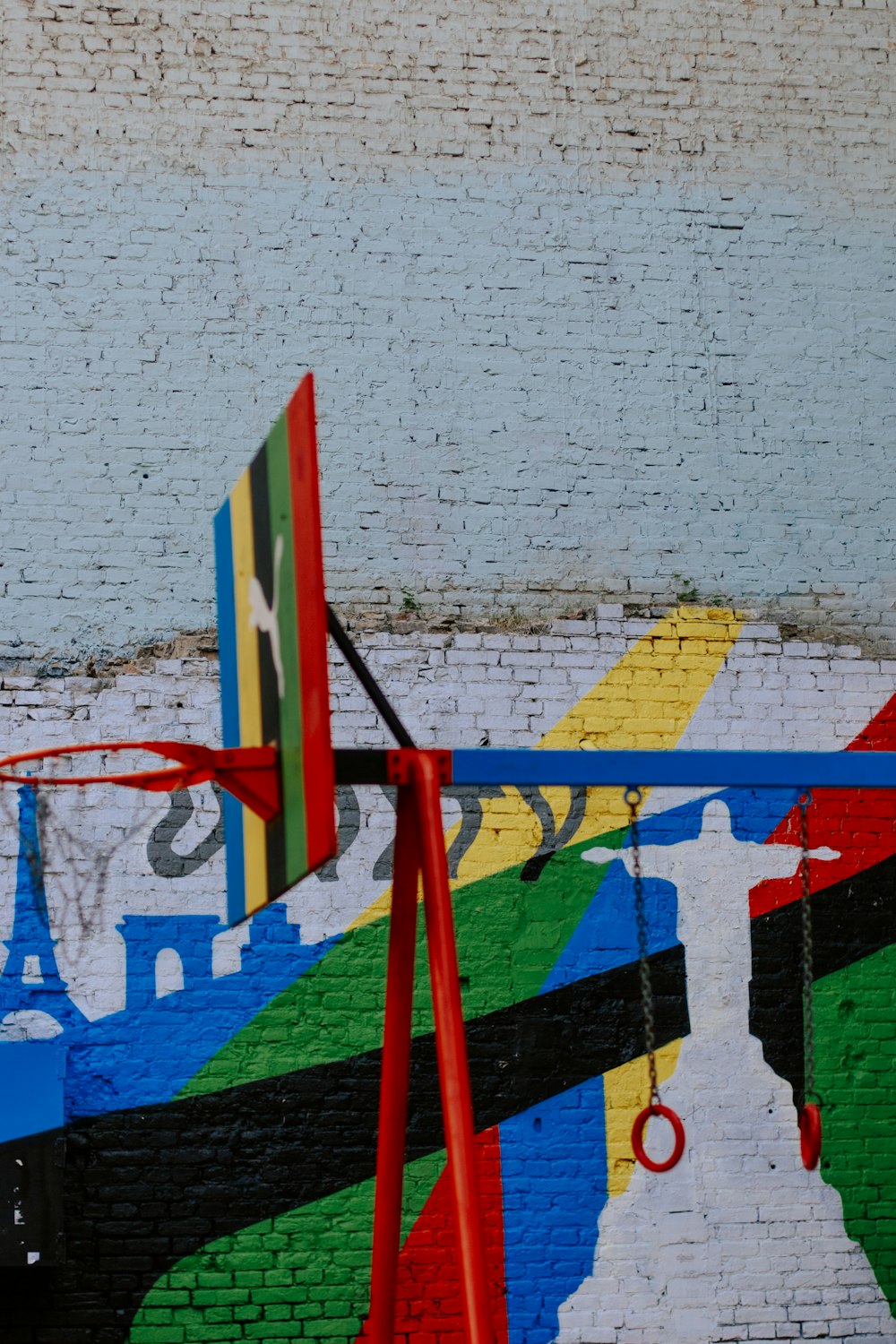 a mural of a basketball hoop in front of a brick wall