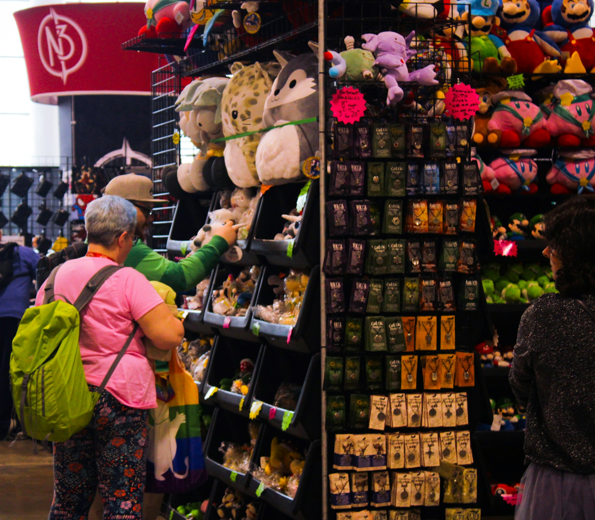 a woman looking at stuffed animals in a store