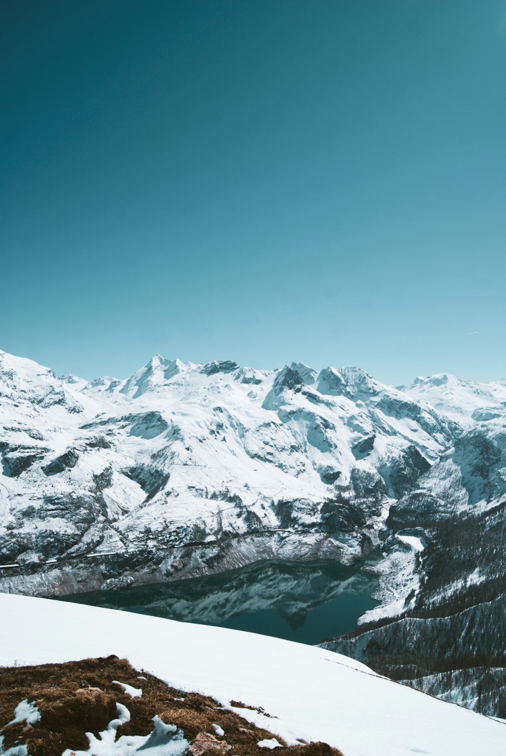 a person standing on top of a snow covered mountain