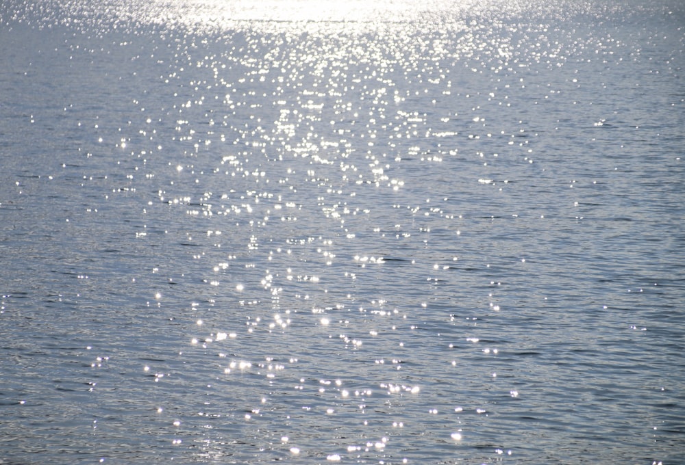 a large body of water with a boat in the distance