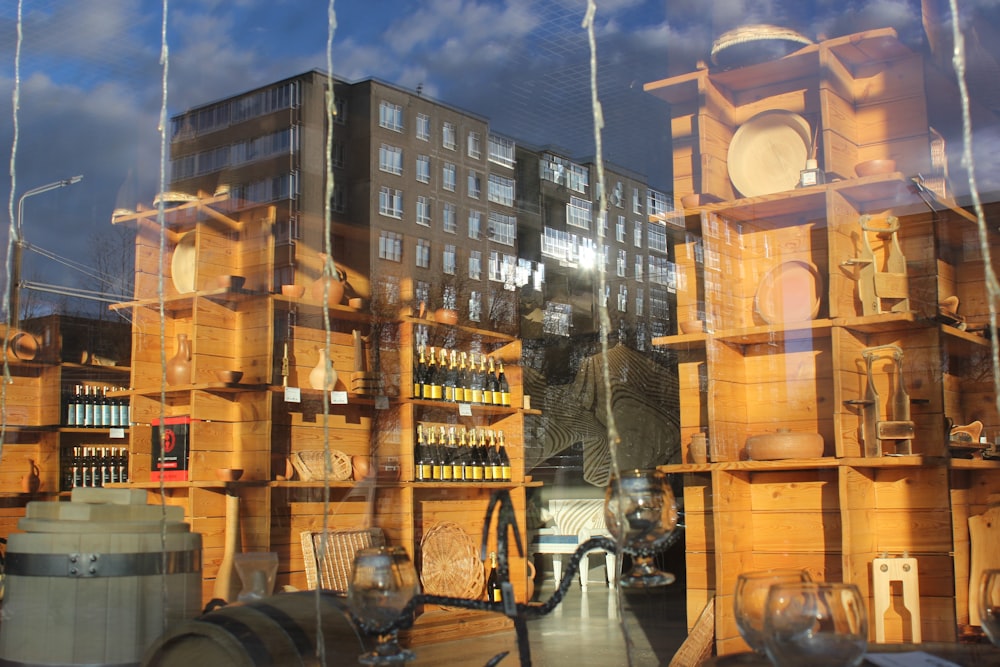 a store front window with many wooden shelves