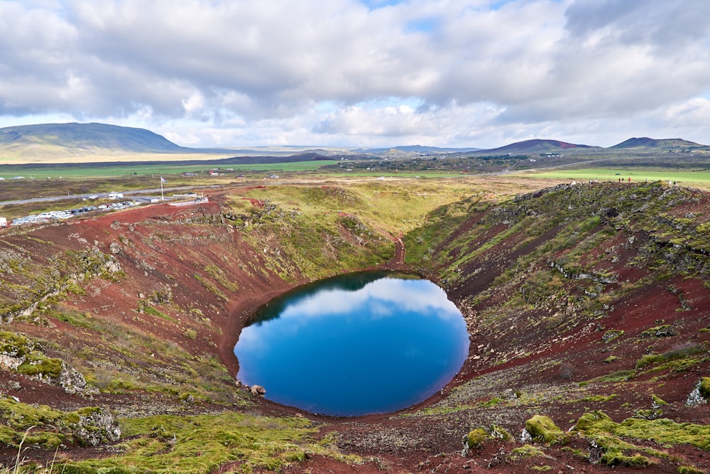 a large blue lake surrounded by green hills