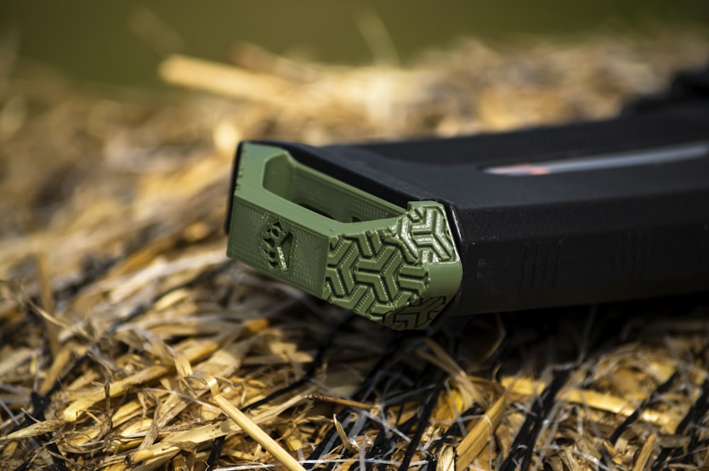 a close up of a knife on a pile of hay