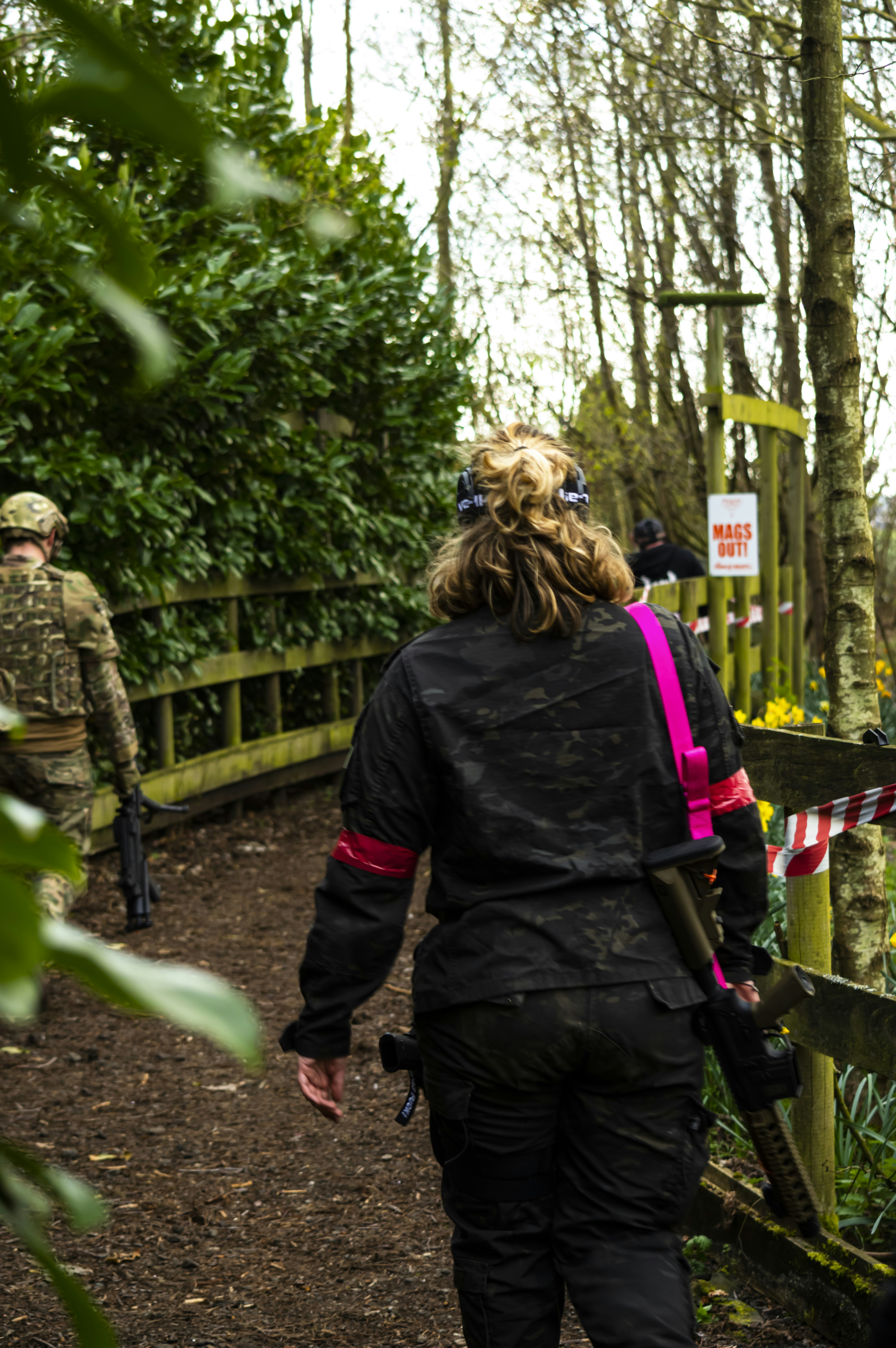 a group of people walking down a path in the woods