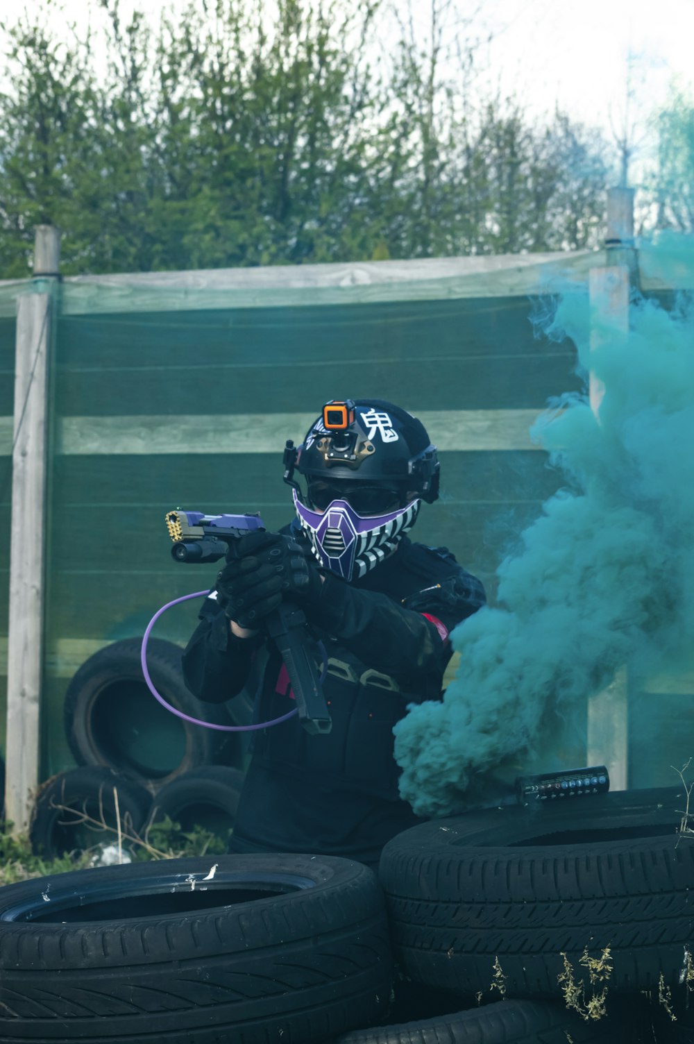 a man with a paintball gun in his hand