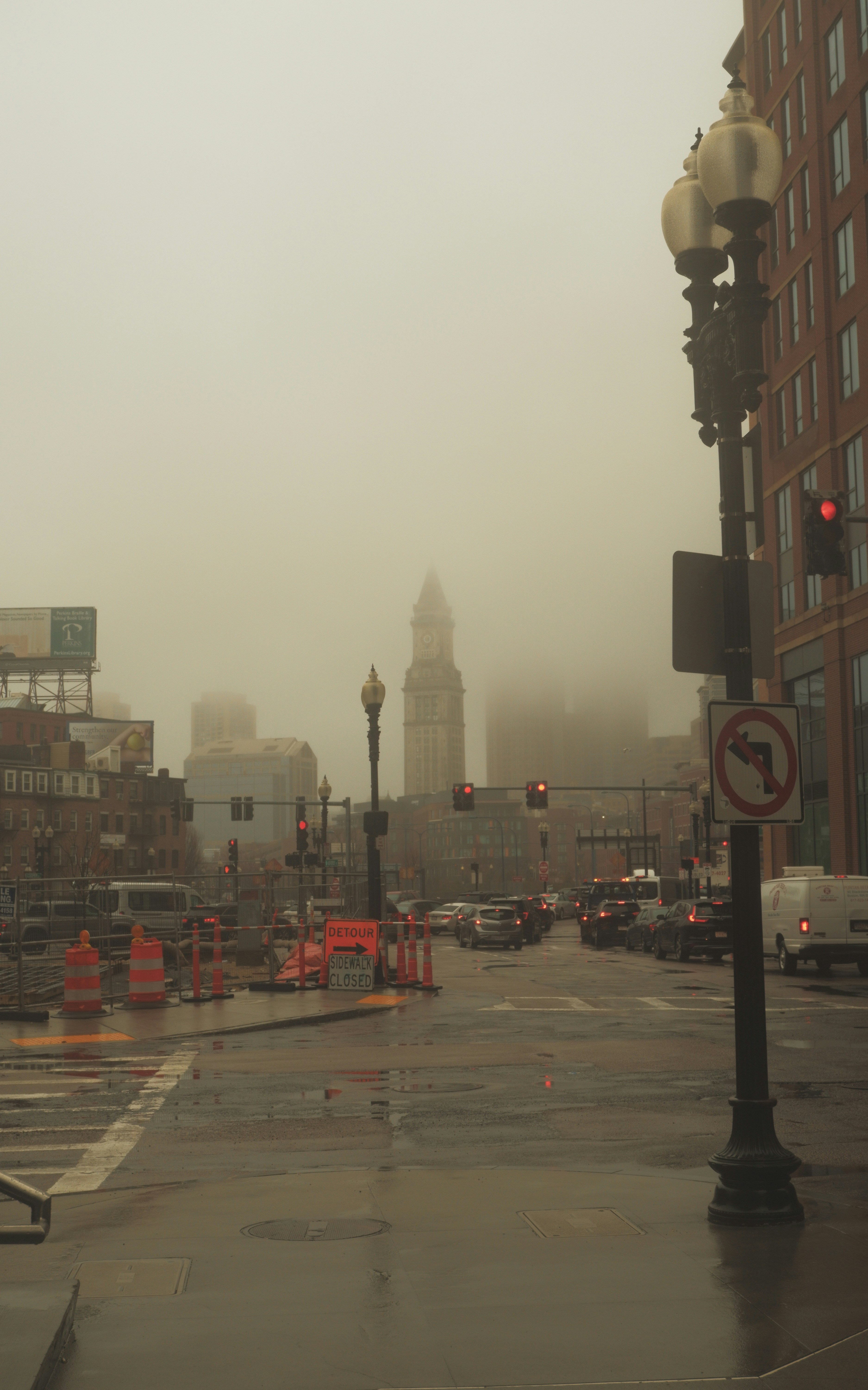 a city street with a lot of traffic on a rainy day
