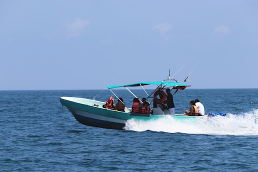 a group of people riding on the back of a boat
