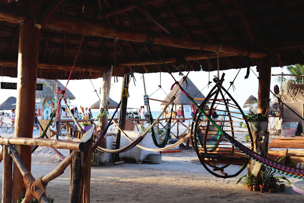 A cozy beachside hut with hammocks swaying gently in the warm island breeze.