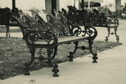 a black and white photo of a row of benches