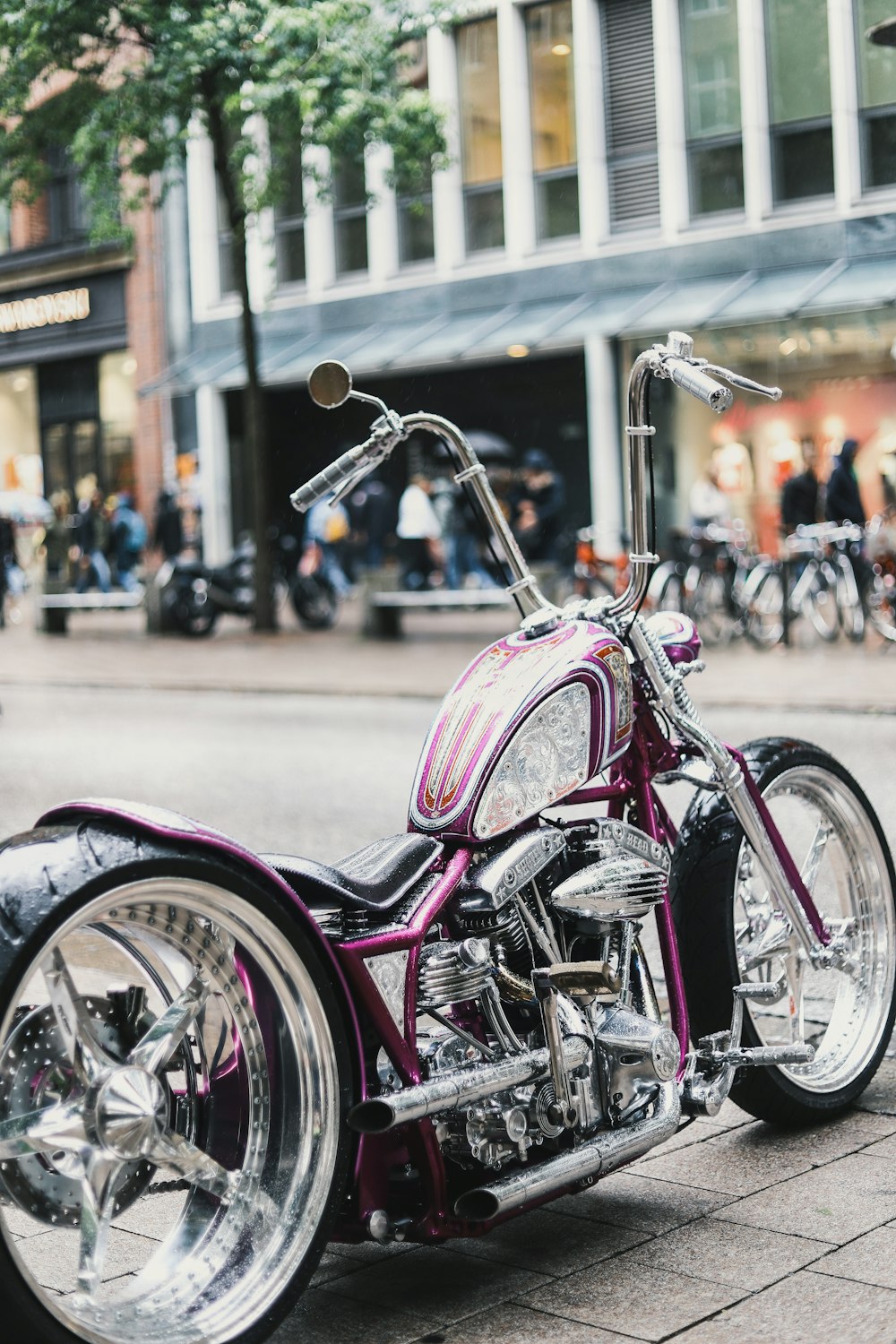 a purple motorcycle parked on the side of a street