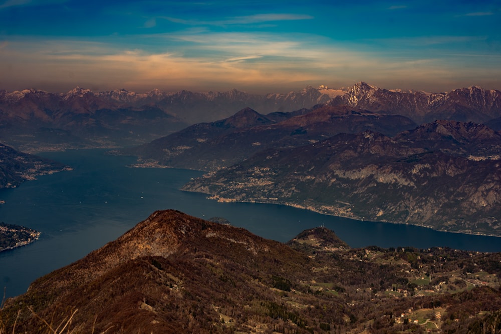 a view of a mountain range with a lake in the foreground