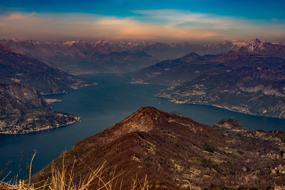 a view of a mountain range with a lake in the foreground