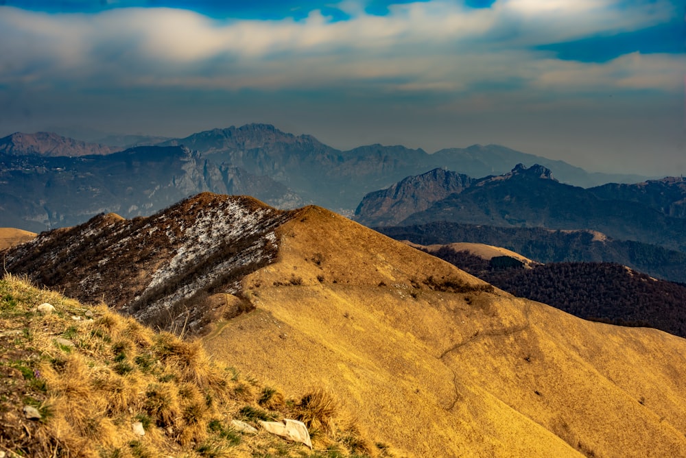 a view of the mountains from the top of a hill