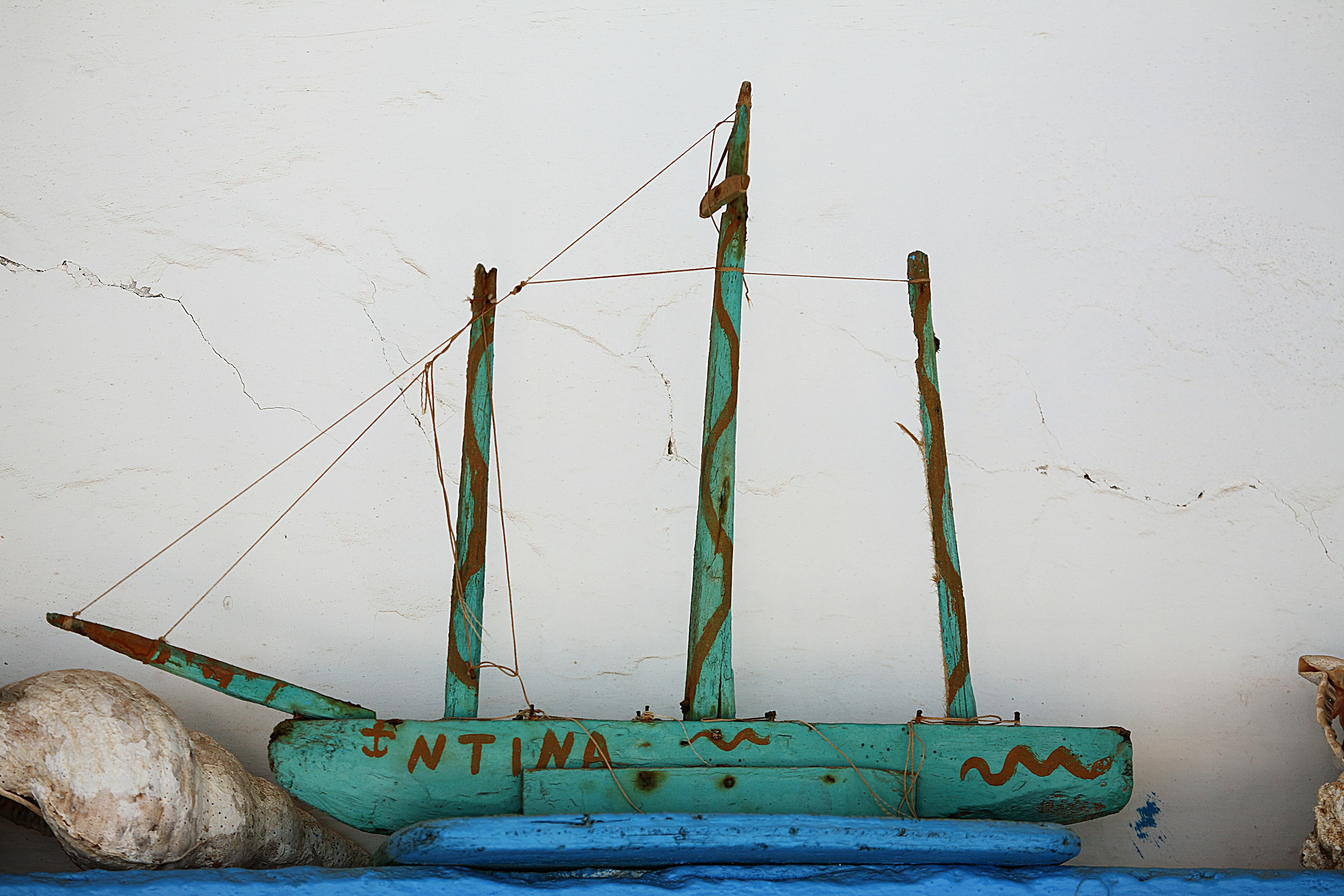 a blue boat sitting on top of a blue table