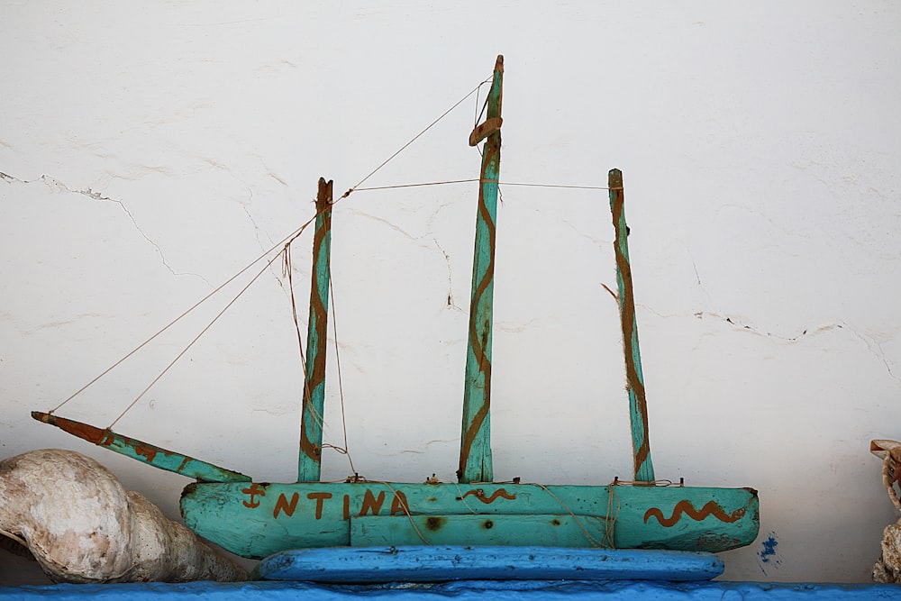 a blue boat sitting on top of a blue table