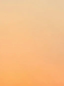 A warm, inviting workspace with soft beige tones and accents of old rose, capturing a serene moment of creativity and focus.