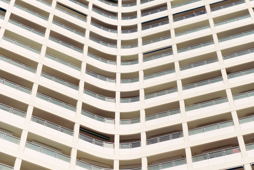 a tall white building with balconies and balconies