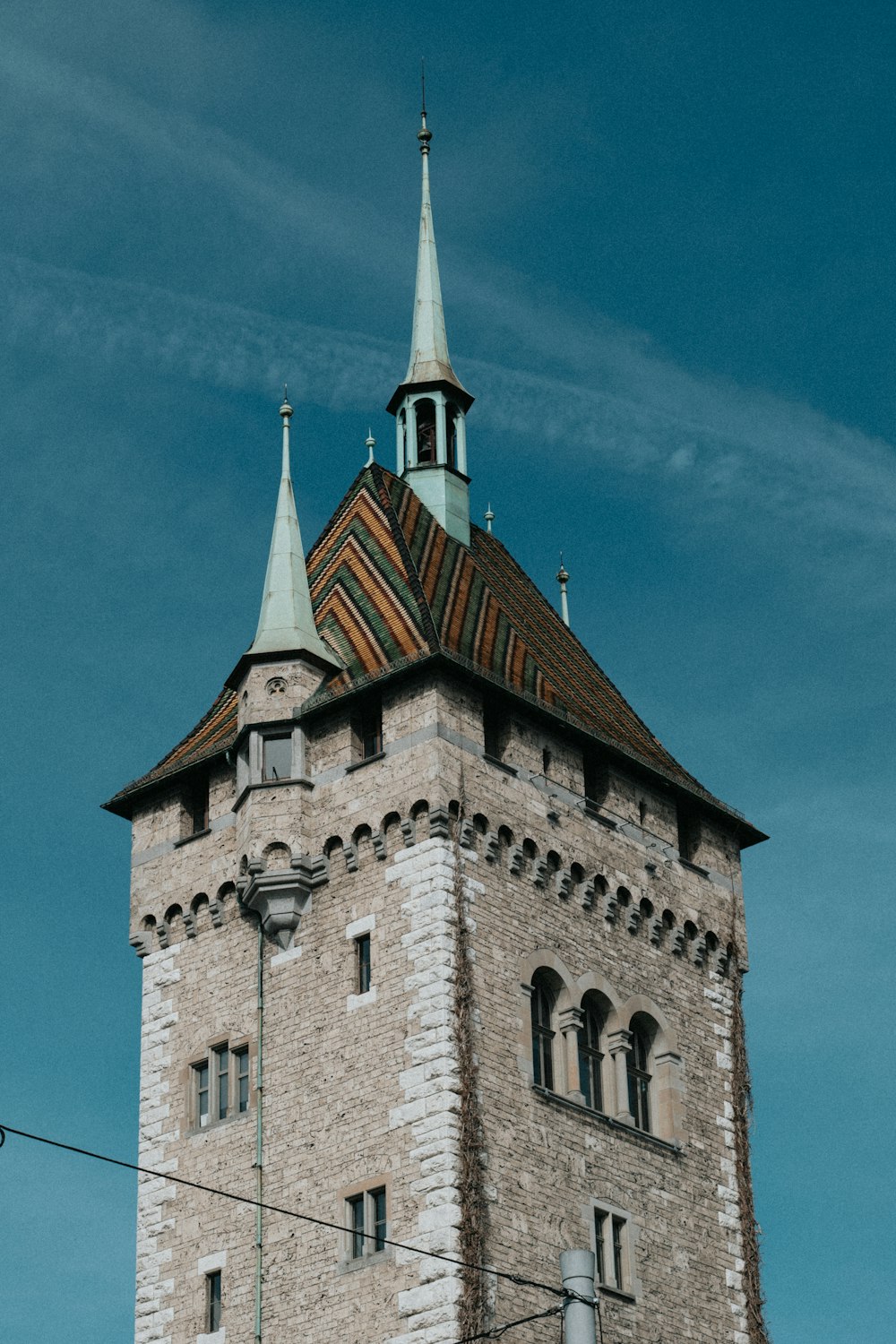 a tall brick tower with a clock on it's side