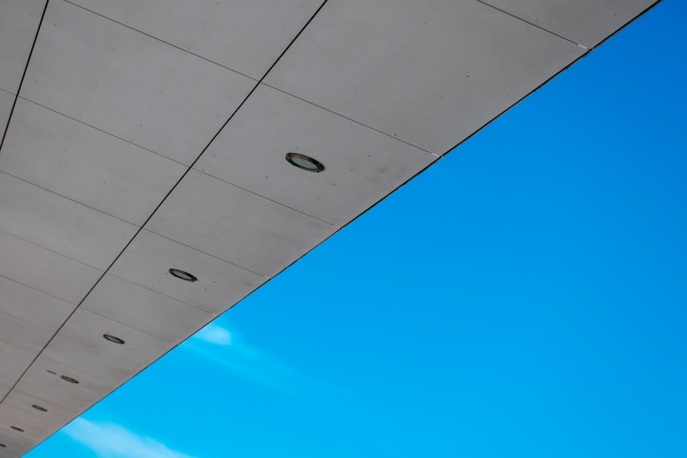 the underside of a building with a blue sky in the background