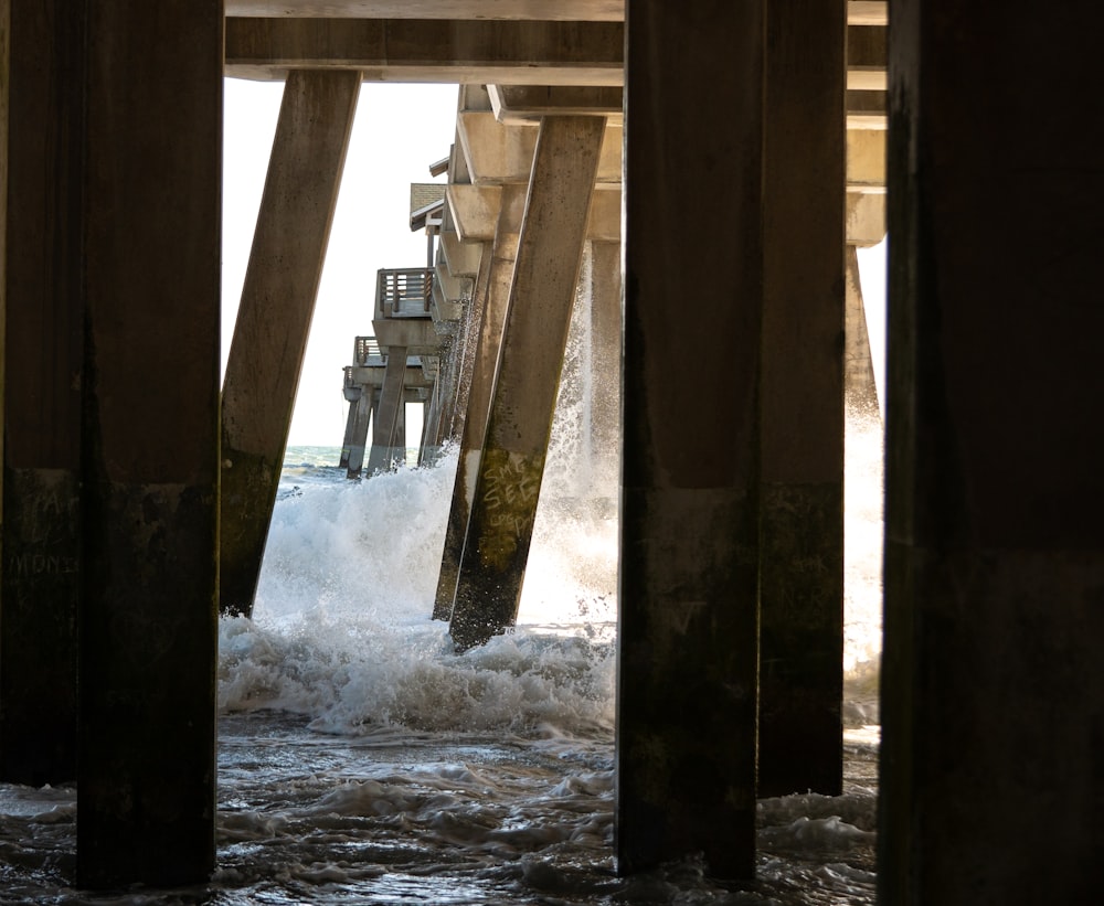 a view of the ocean from under a pier