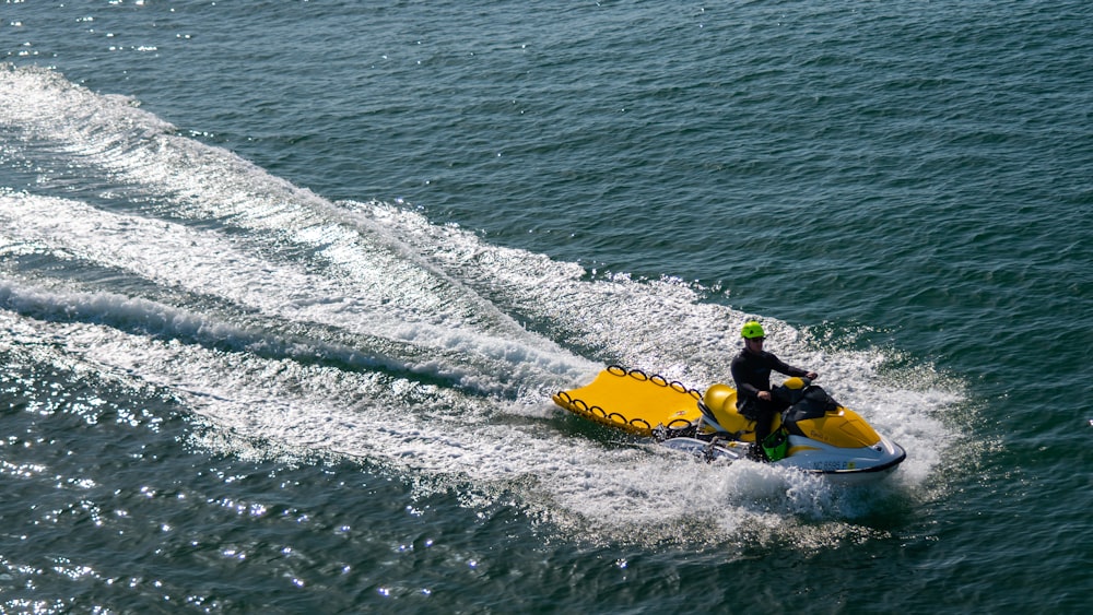 a man riding a jet ski on top of a body of water