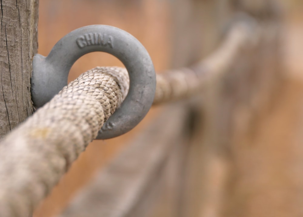 a close up of a rope on a wooden post