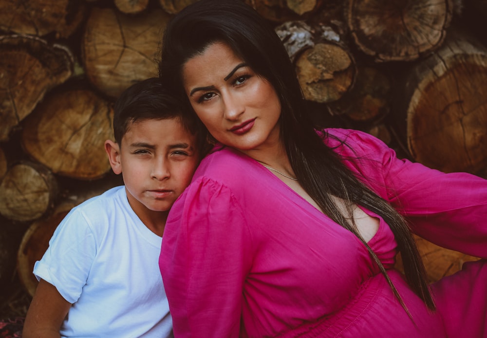 a woman and a boy are posing for a picture