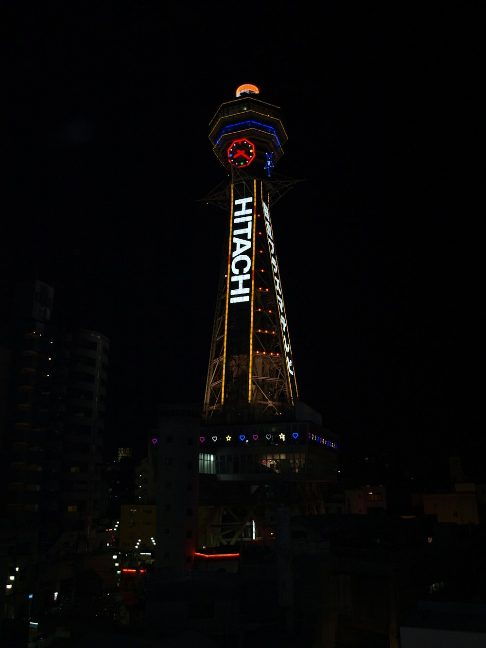 a large clock tower lit up at night