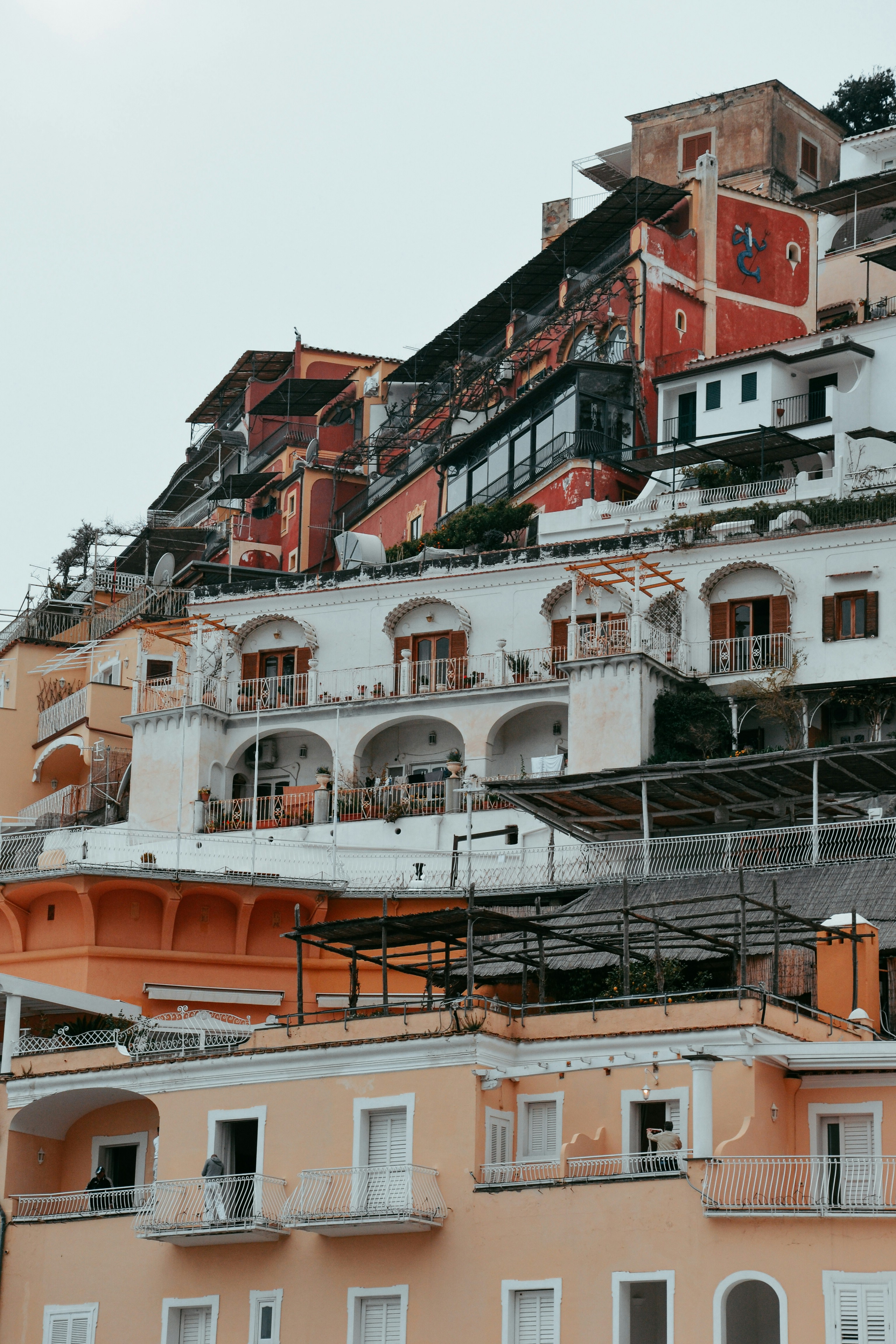 a very tall building with lots of balconies on top of it