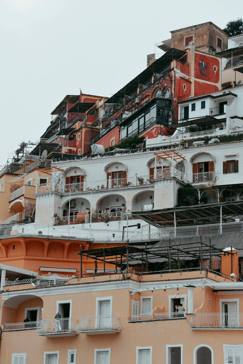 a very tall building with lots of balconies on top of it