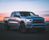 a silver ram truck parked in a parking lot