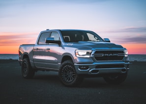 a silver ram truck parked in a parking lot