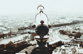 a telescope on top of a building overlooking a city