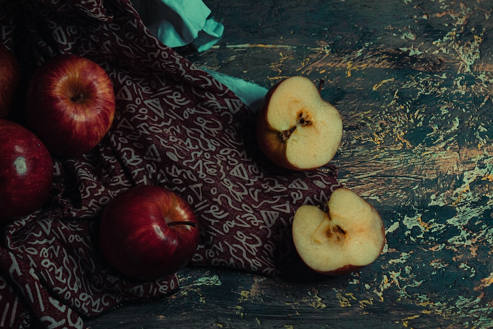 a table topped with apples on top of a cloth