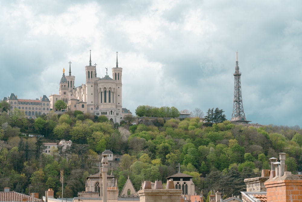 a castle on top of a hill surrounded by trees