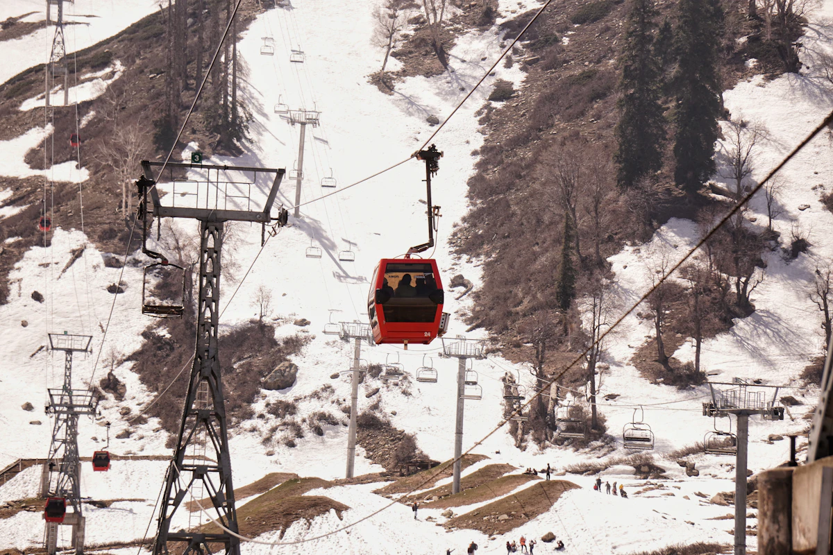 Gondola climbing a snowy mountainside