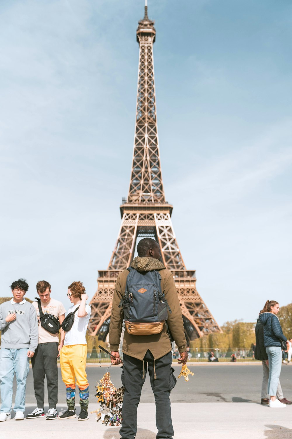 a man standing in front of the eiffel tower