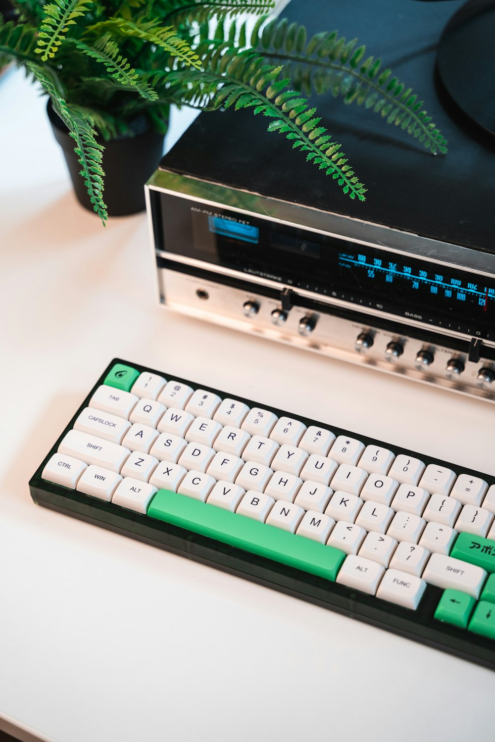 a green and white keyboard sitting on top of a table