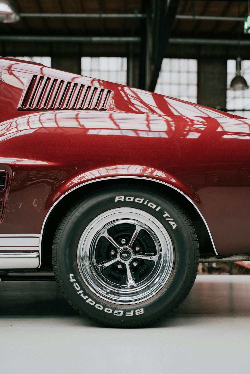 a red car parked inside of a garage