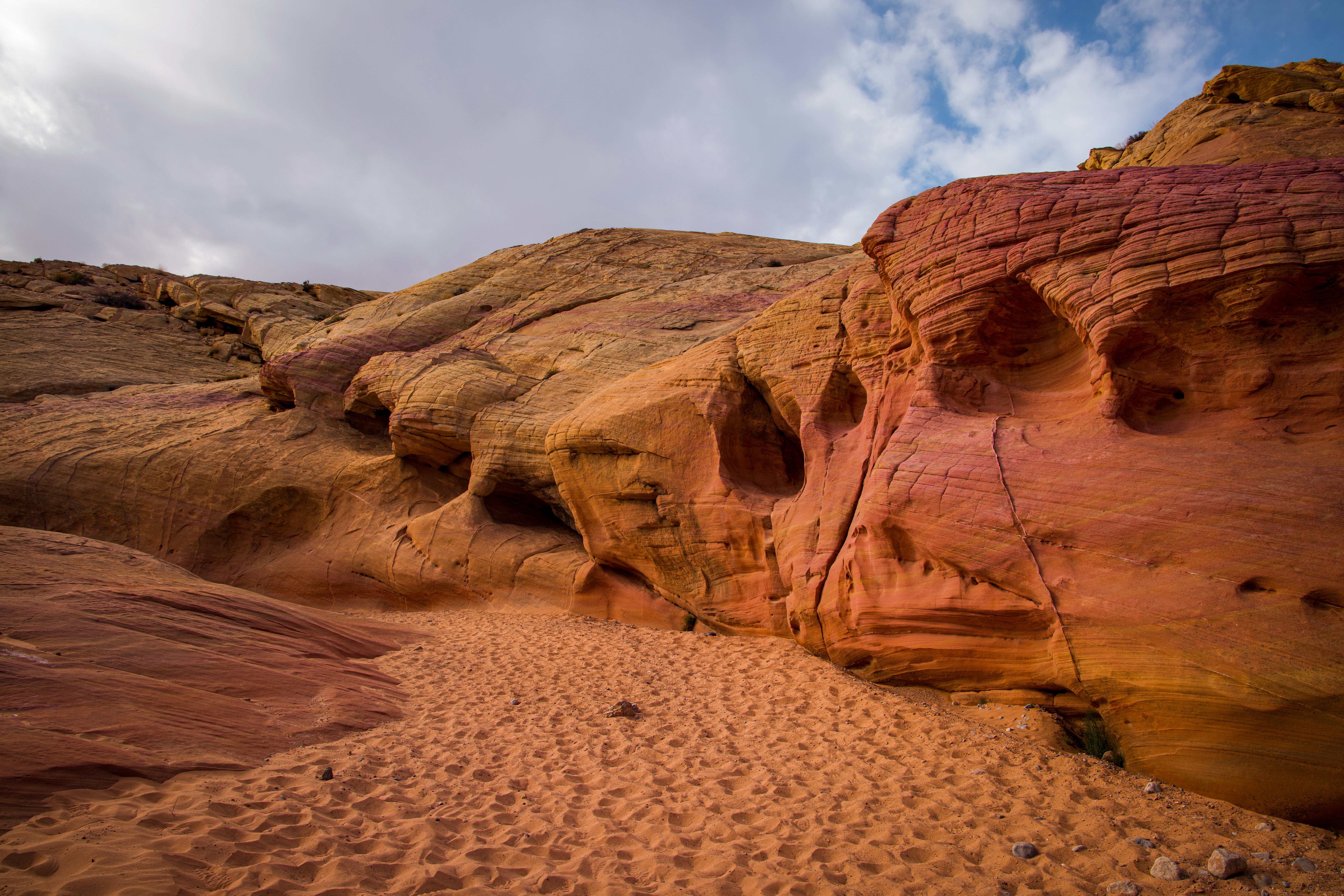 a large rock formation with a sky in the background