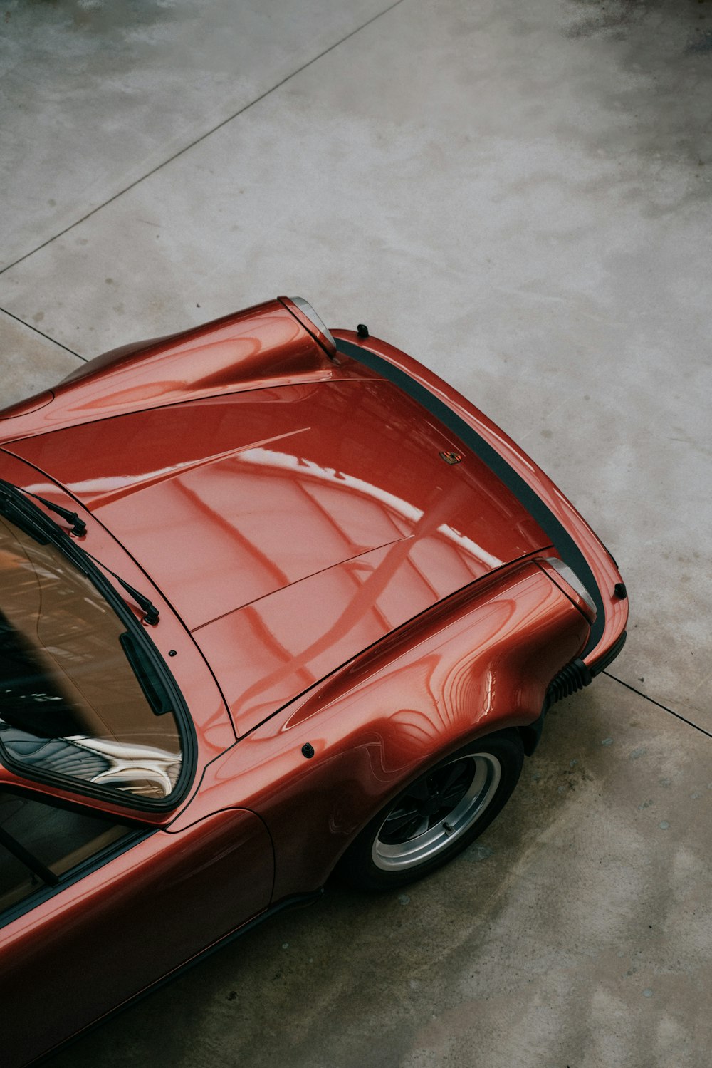 a red sports car parked in a parking lot