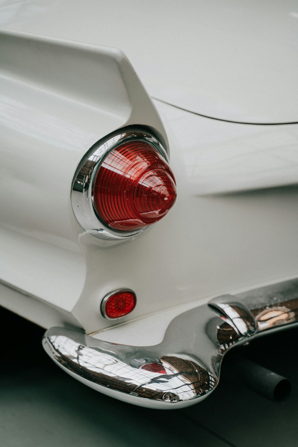 a close up of the tail lights of a white car