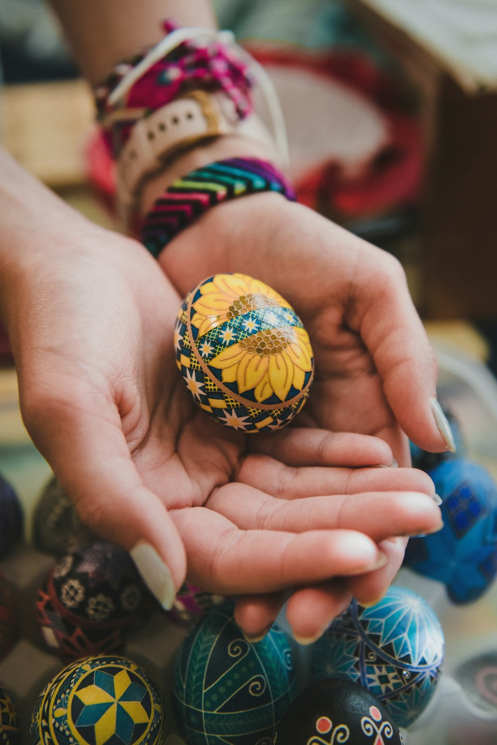 a person holding an easter egg in their hands