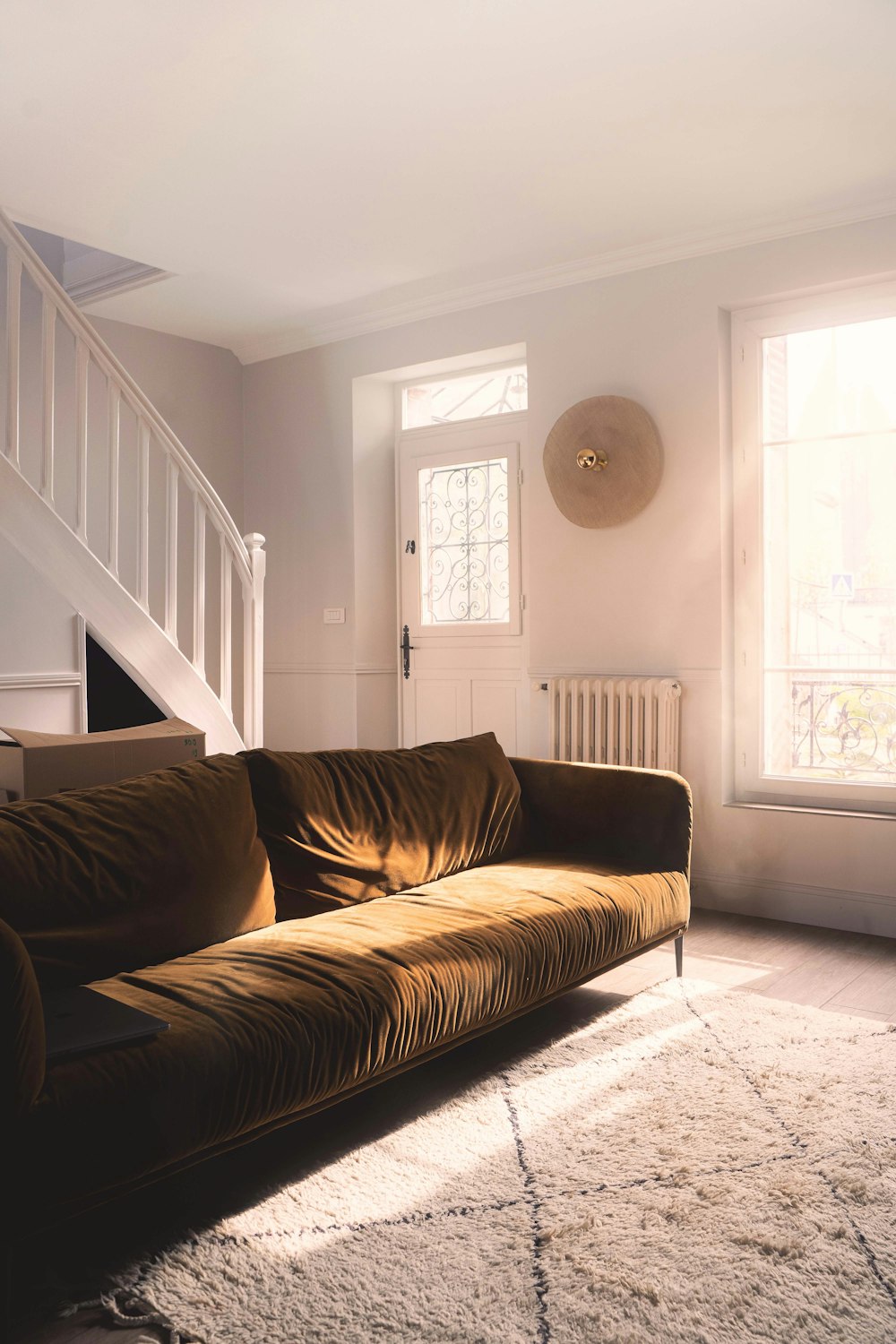 a living room with a couch and a stair case