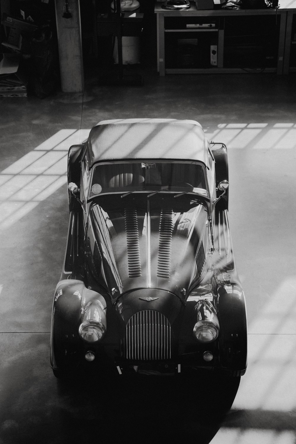 a black and white photo of a car in a garage