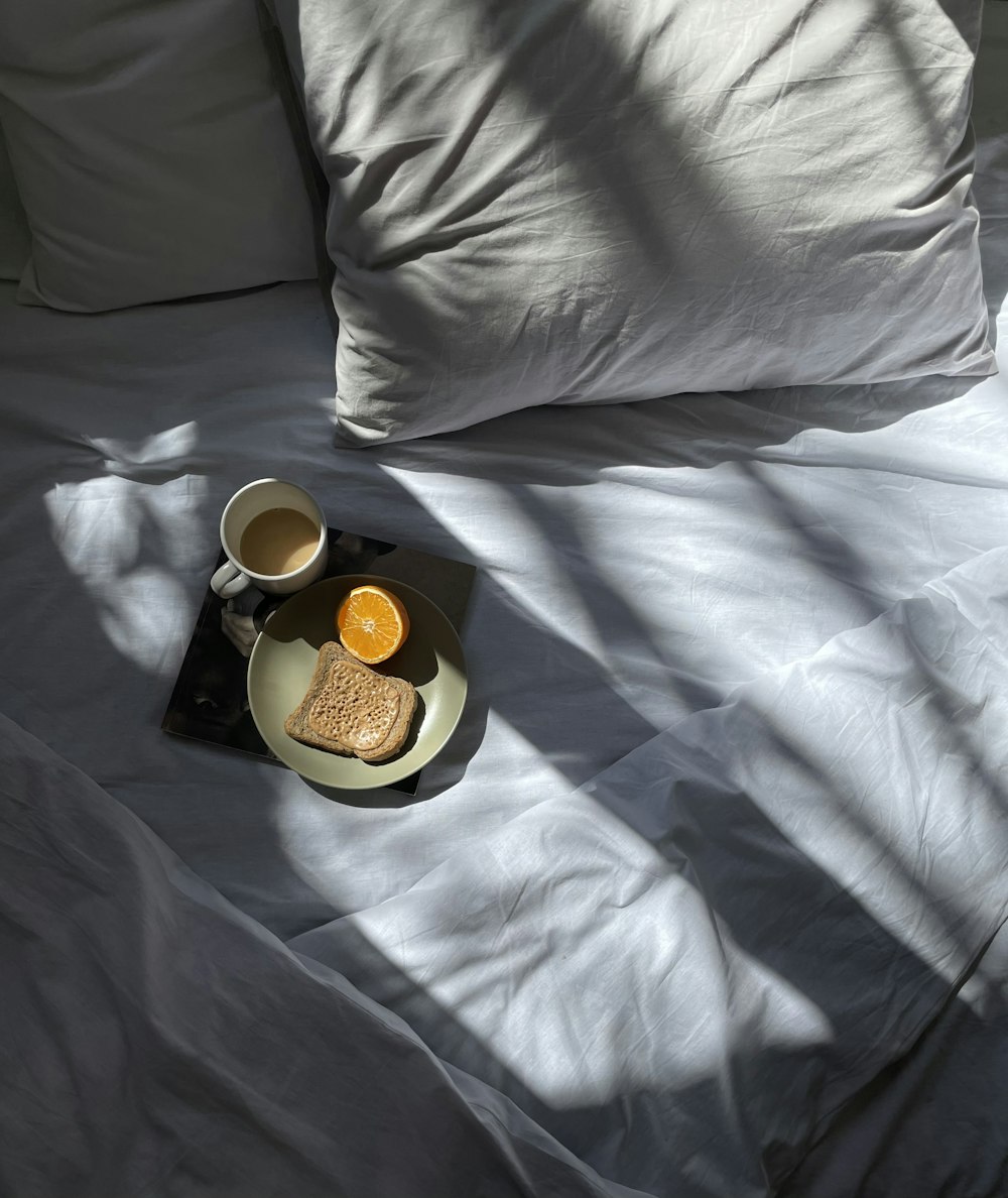 a tray of toast and a cup of coffee on a bed