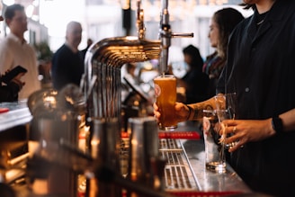 a man pouring a drink at a bar